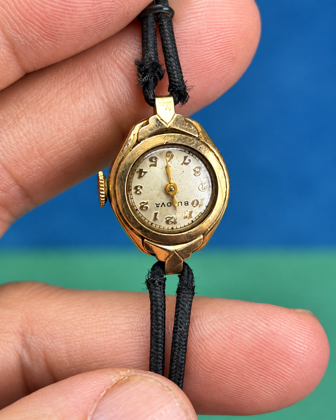 Vintage Bulova watch with badly frayed black cord bracelet