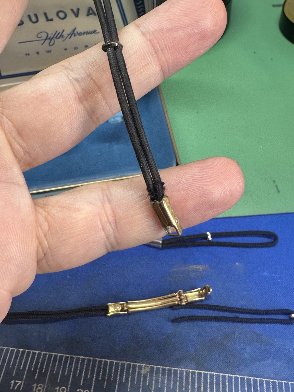 Replacement cord being fitted into original vintage watch bracelet end hardware