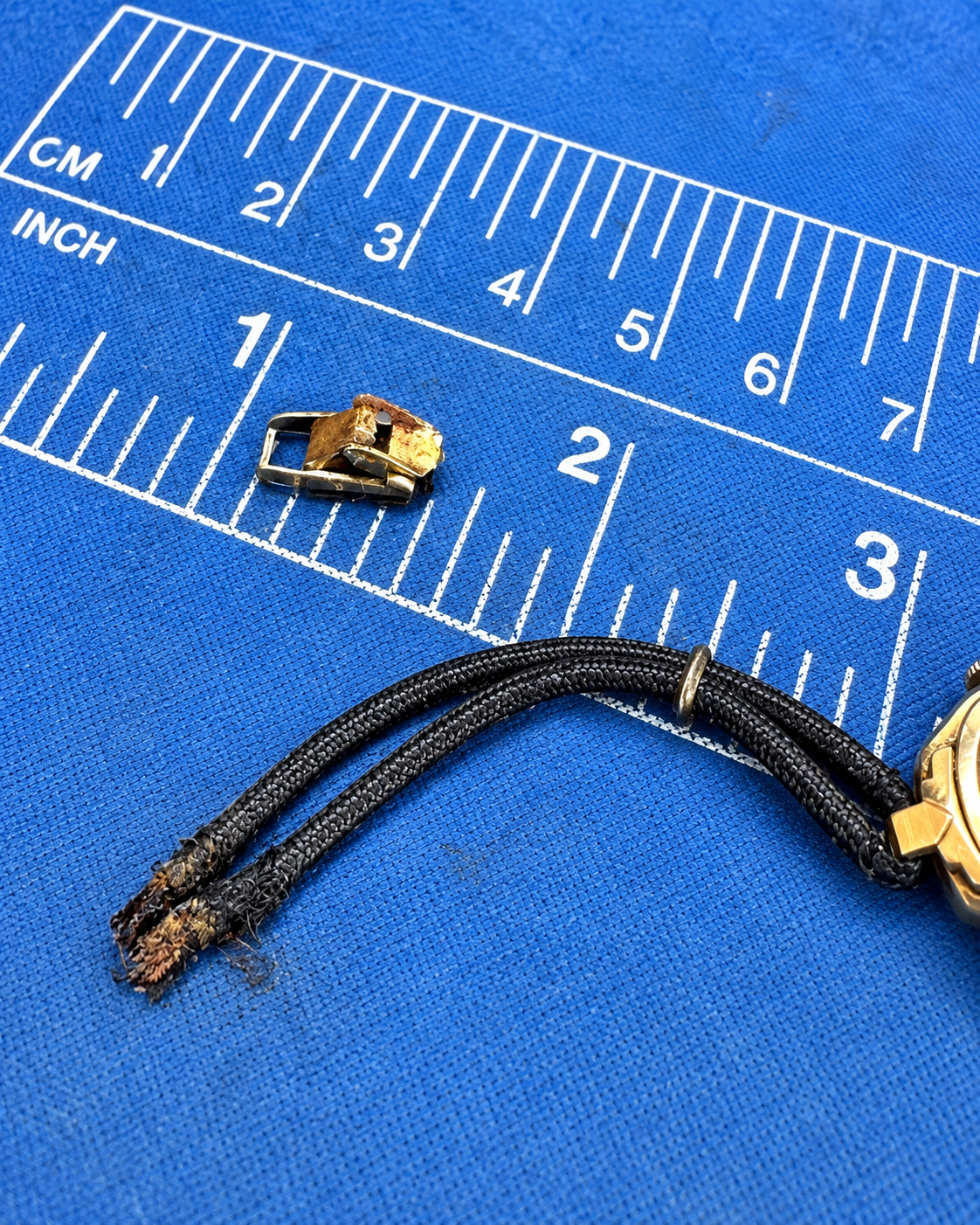 Original clasp and cord bracelet hardware removed from vintage watch