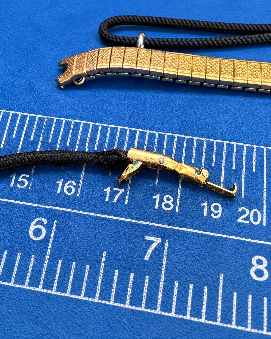 Vintage watch bracelet clasp and end hardware during restoration