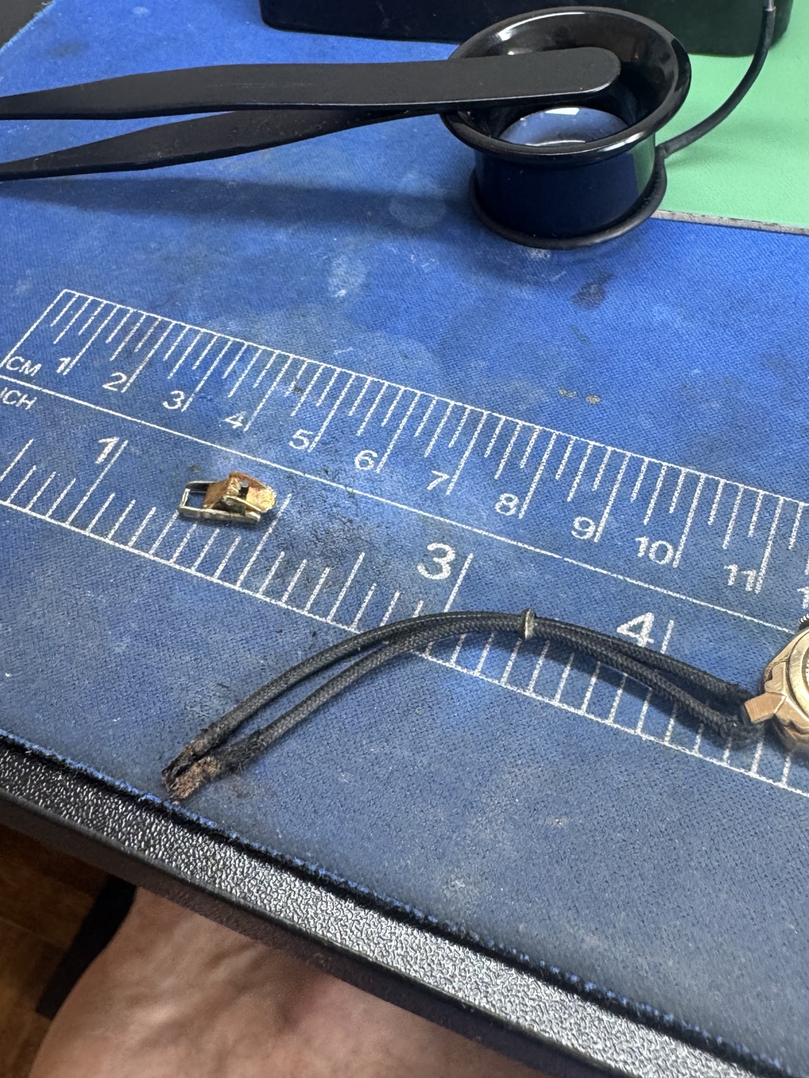 Frayed and damaged end of original vintage watch bracelet cord